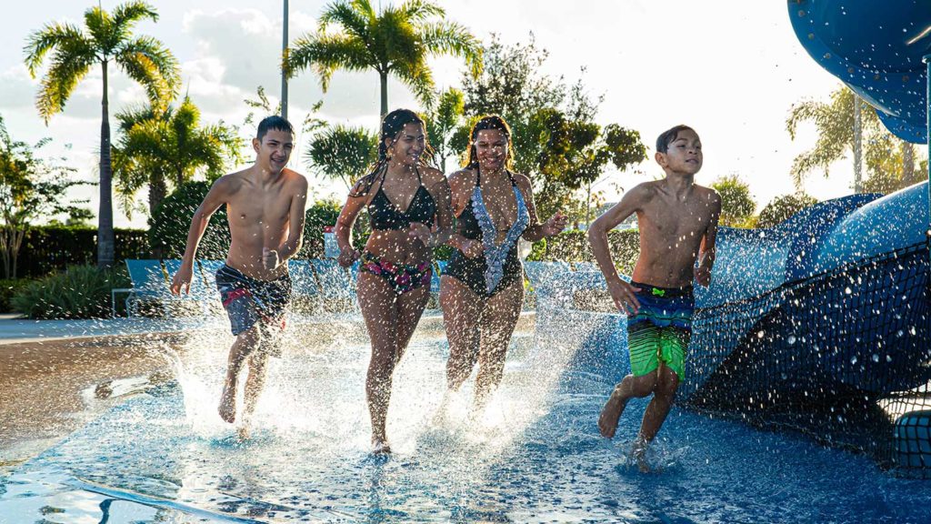 A group of kids splashes through the Encore Resort Water Park.