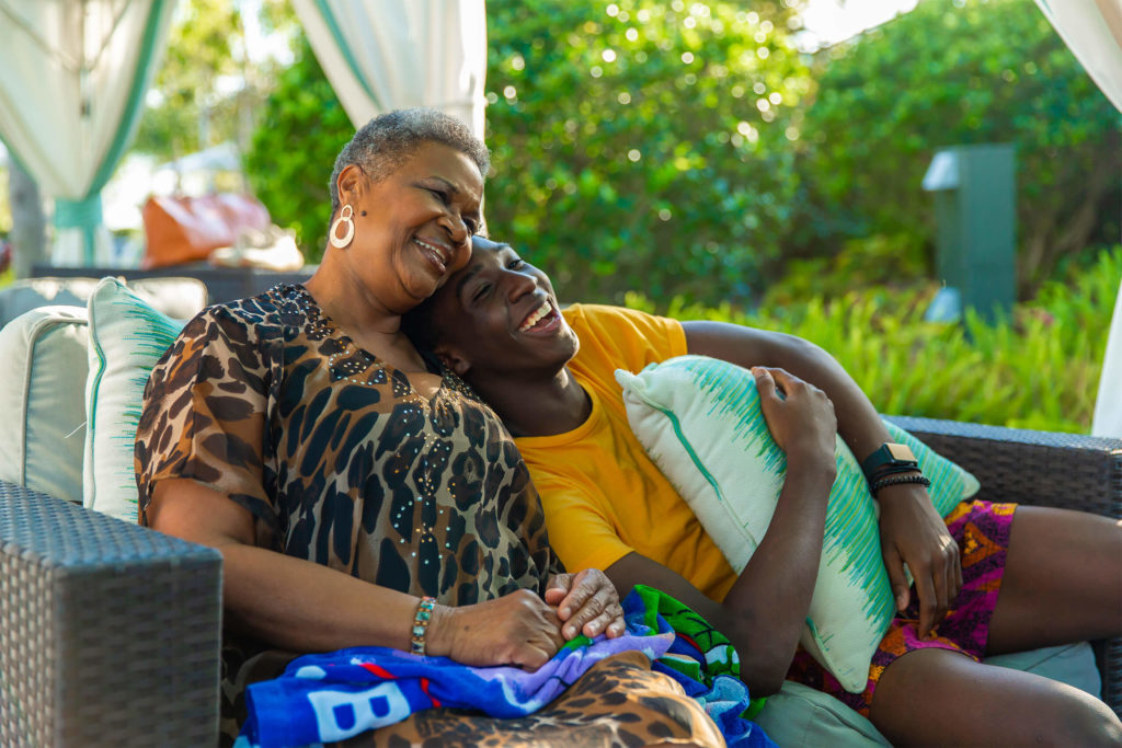 A grandmother and teenage grandson relax in one of the Encore Resort Water Park’s private poolside cabanas.