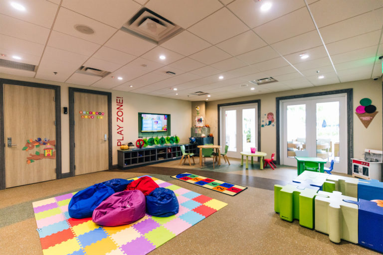Bean bag chairs and large puzzles pieces decorate the floor of the Hang Ten Hideaway kids’ play area.
