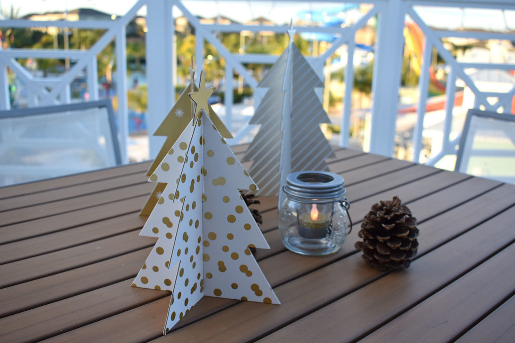 Paper Christmas tree table toppers on a table on the Encore Resort Terrace.