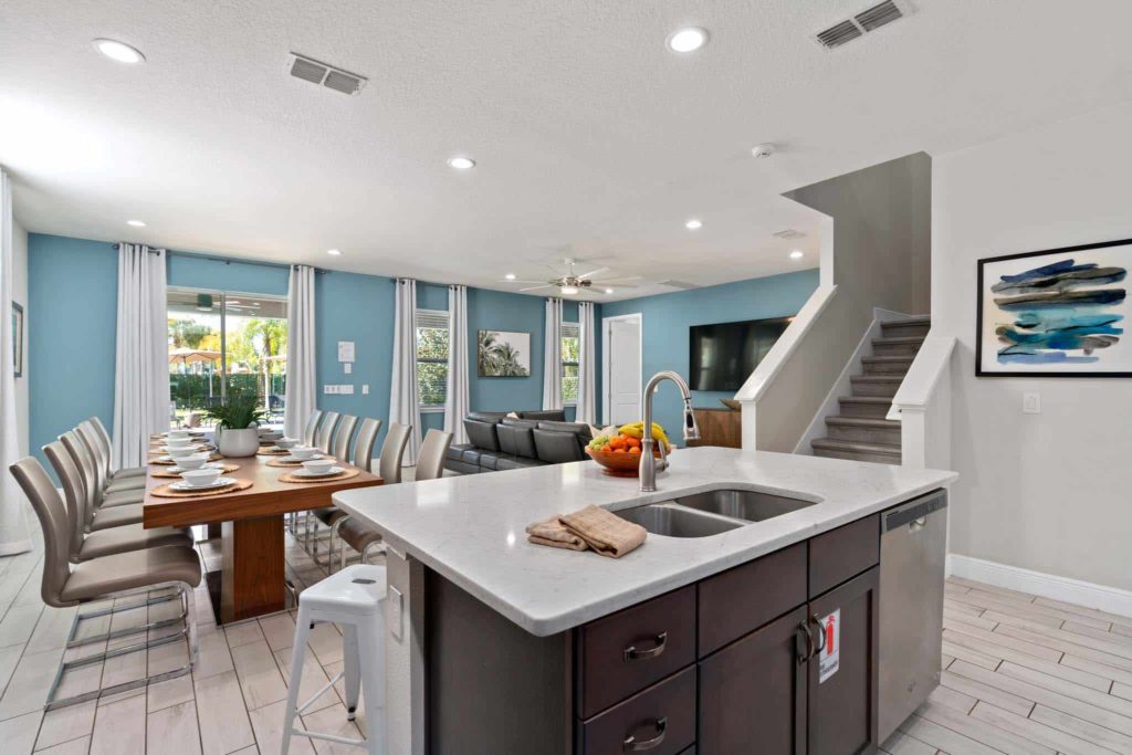 Spacious dining room and large kitchen island with sink in Weathers’ Orlando vacation home.