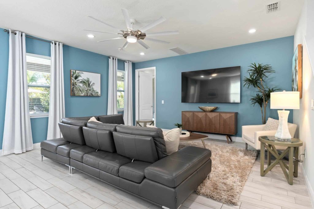 Living room with reclining couch and large, flat-screen TV in Weathers’ Orlando vacation home.