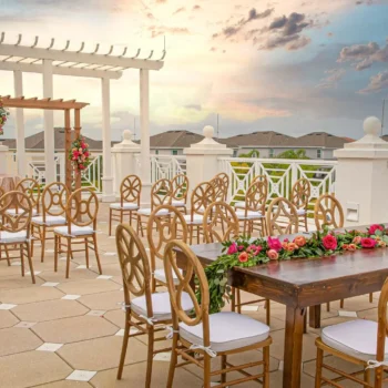 Encore's outdoor clubhouse terrace decorated for a wedding at sunset.