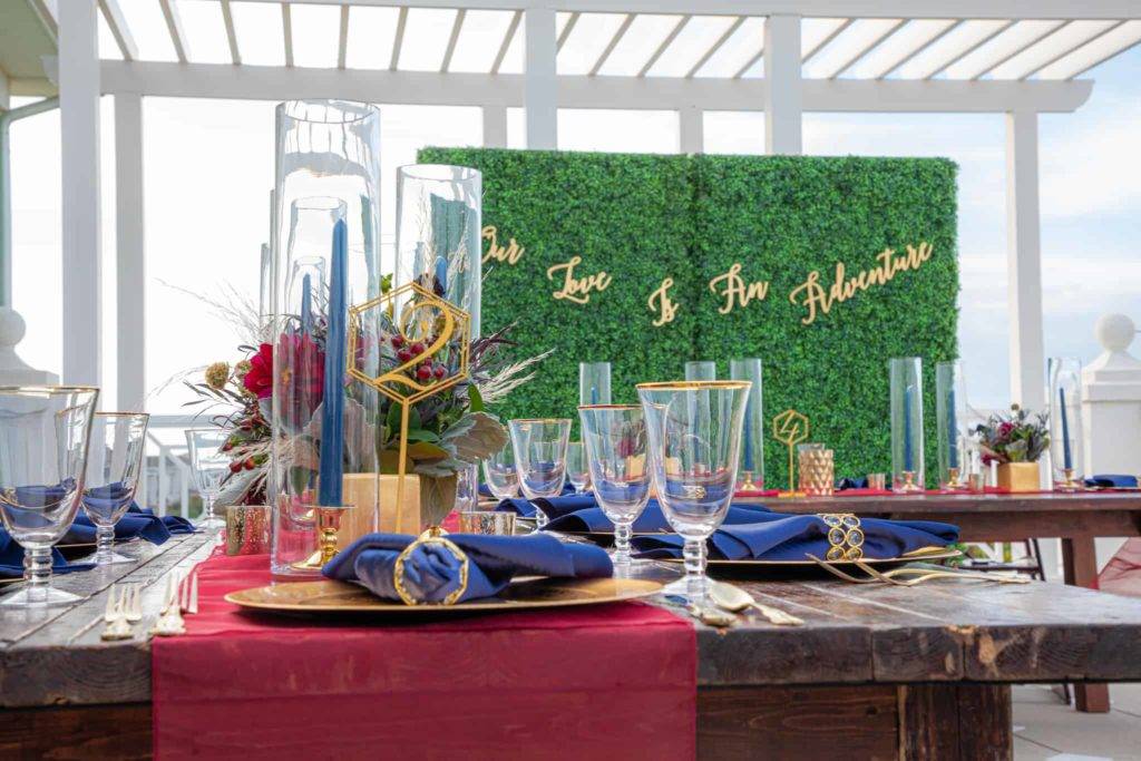 Wedding reception on the Encore Resort Clubhouse terrace with a backdrop reading: Our Love is An Adventure