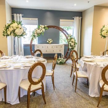 Encore Resort private dining room set up for a wedding reception with tables and entrance archway