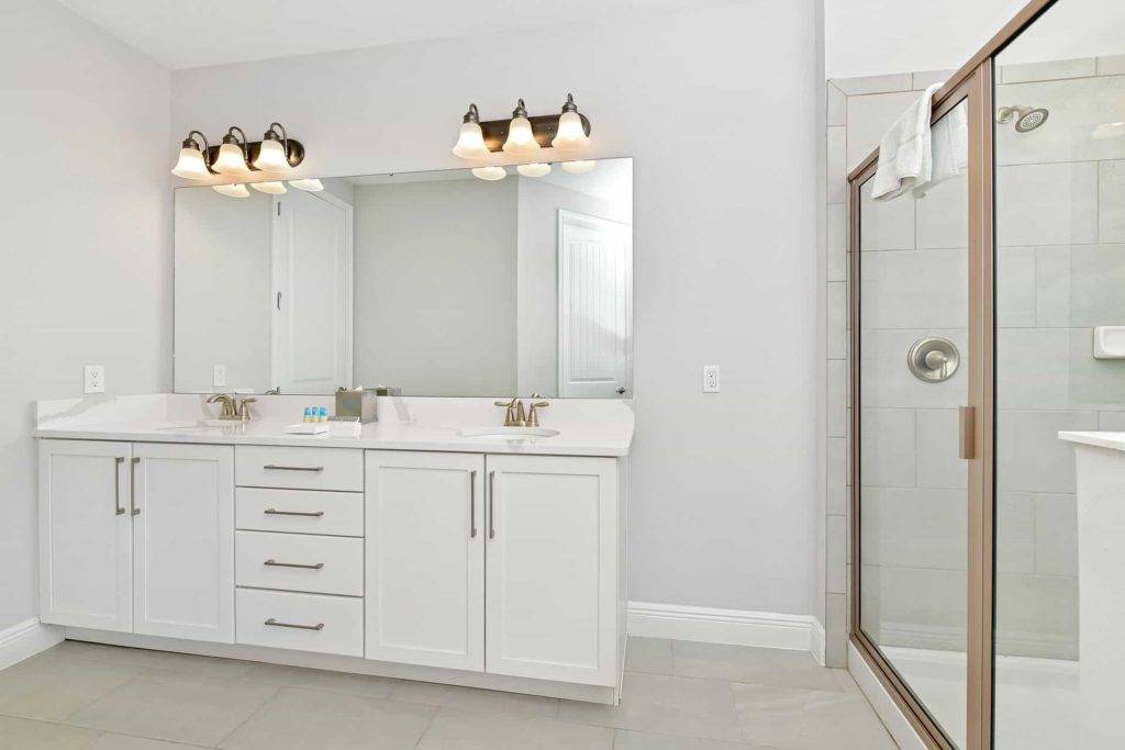 Bathroom 3 with double sink and glass-door shower