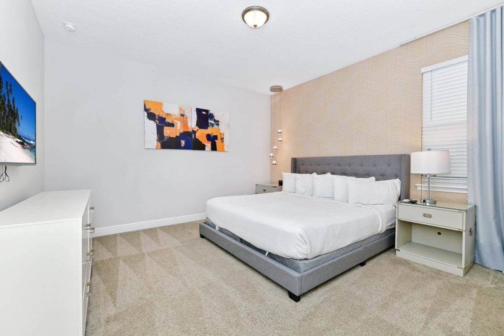 Bedroom 2 with king bed and wall-mounted TV