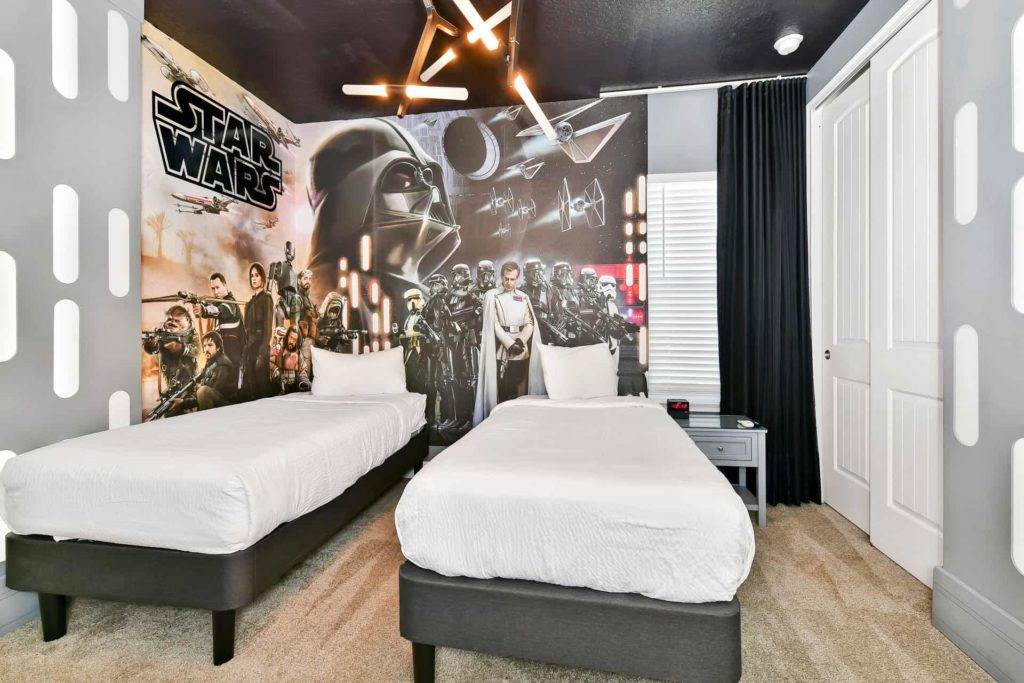 Bedroom 5: Twin bedroom with 2 single beds and Star Wars themed decor, wallpaper, and Light saber shaped ceiling light