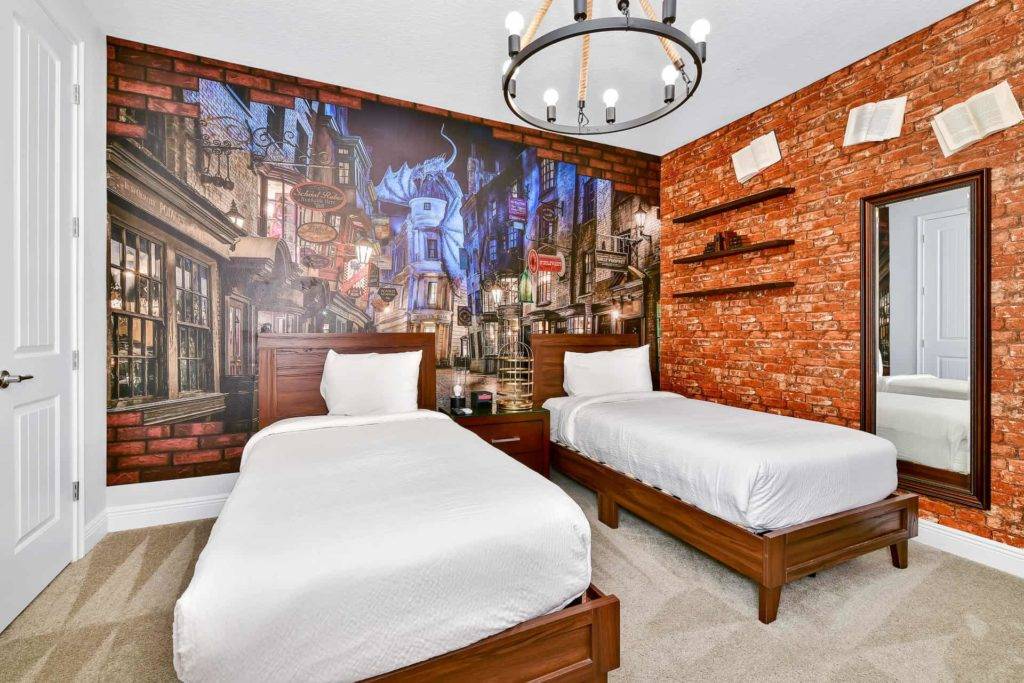 Bedroom 6: Twin bedroom with 2 single beds and Harry Potter themed wallpaper, chandelier, and wall decor