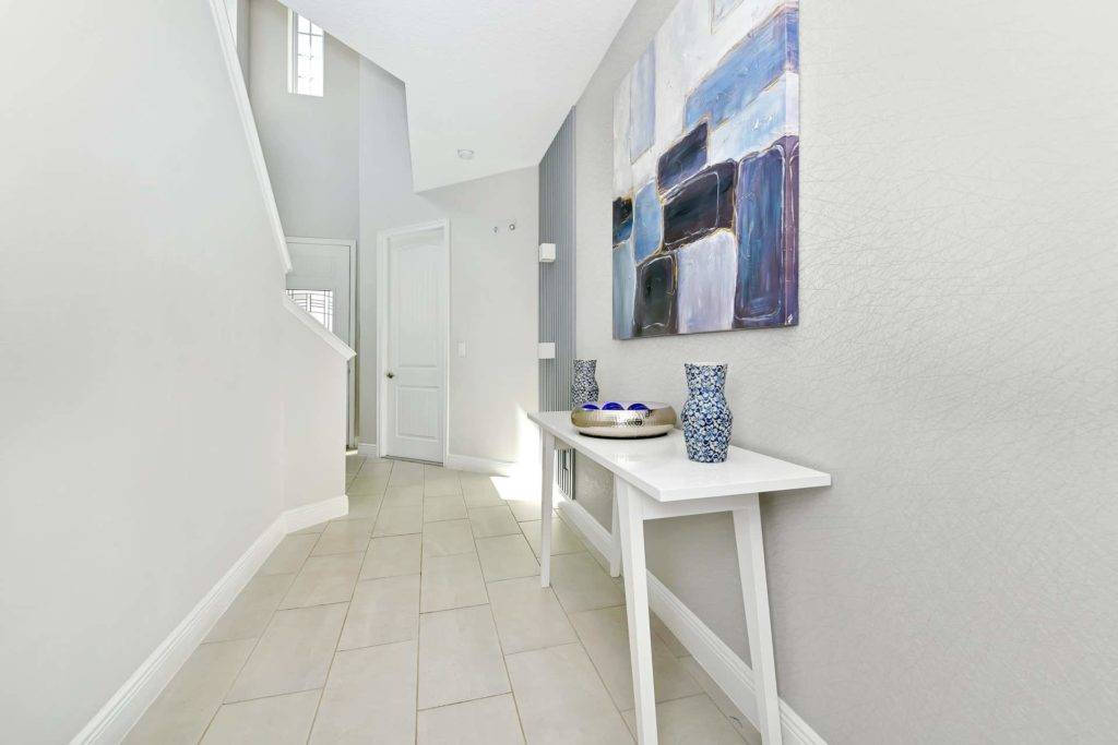 Entrance foyer with end table and stairs to upper level