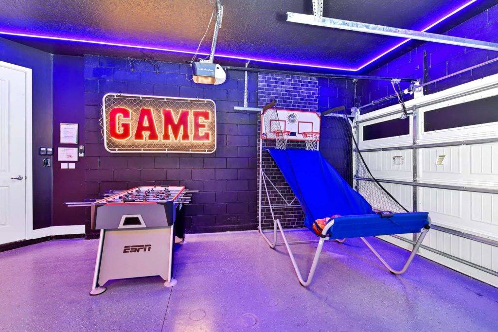 Arcade basketball and foosball table in a themed game room