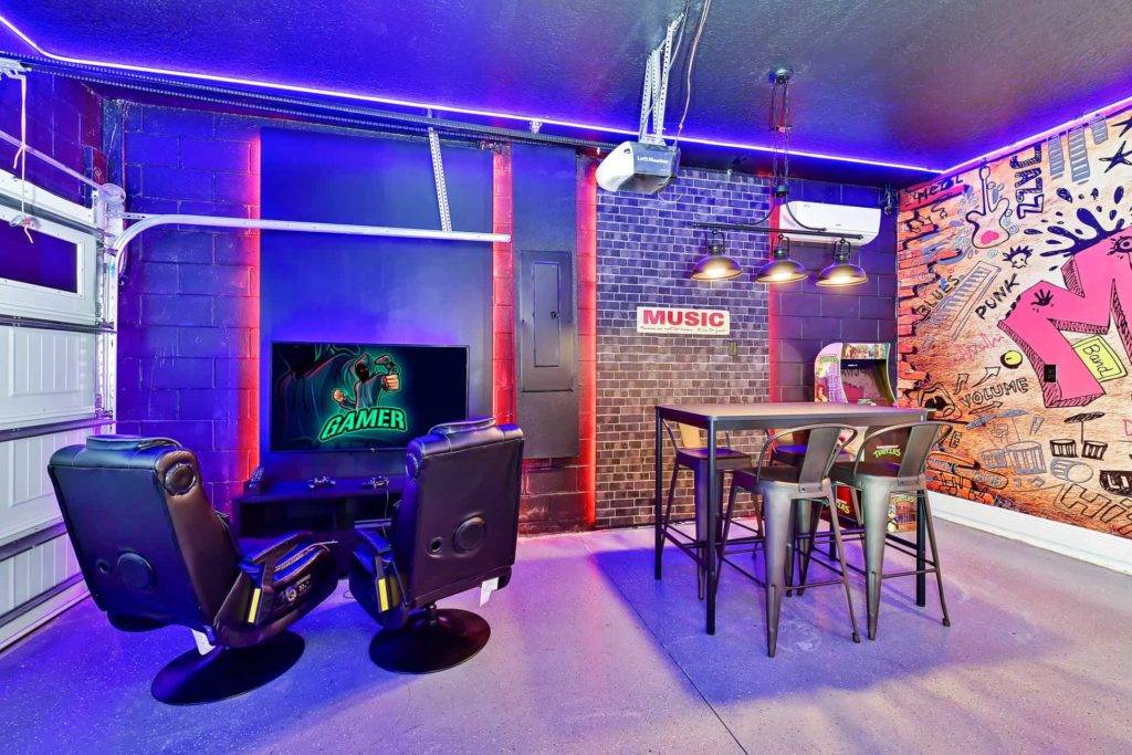 Gaming chairs and TV in themed game room