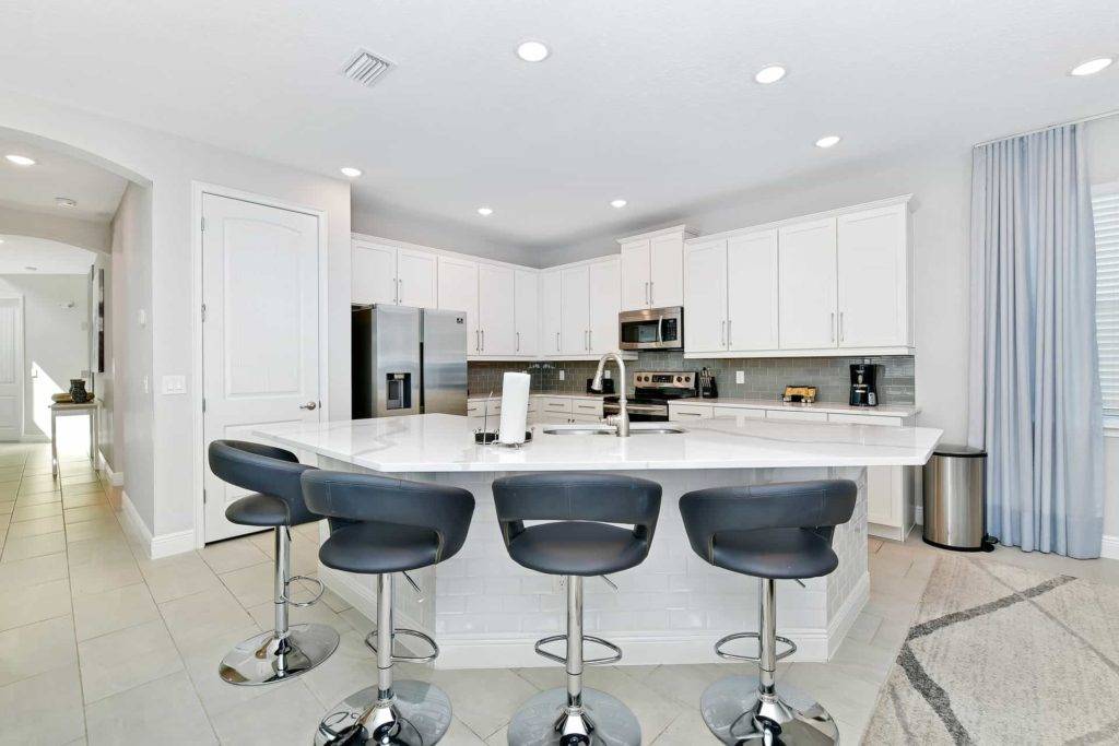 Fully equipped kitchen with large island sink and barstool seats