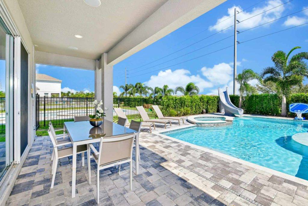 Covered lanai and private pool with hut tub and slide