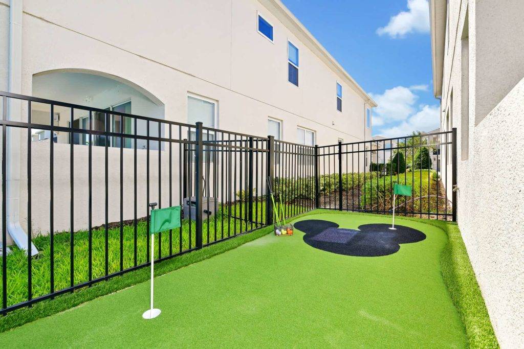 Backyard putting area with Mickey Mouse-themed green