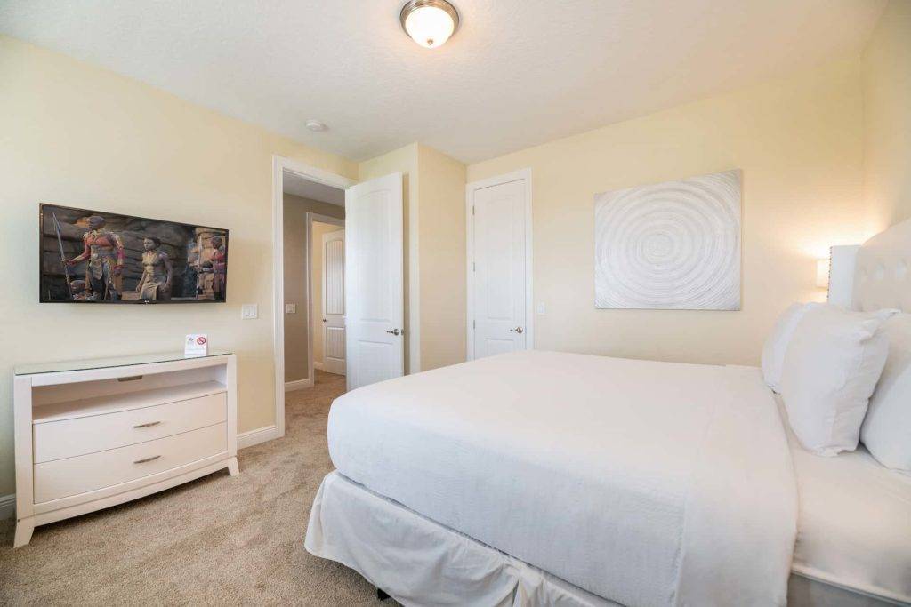 Bedroom 2 with king bed and wall-mounted TV
