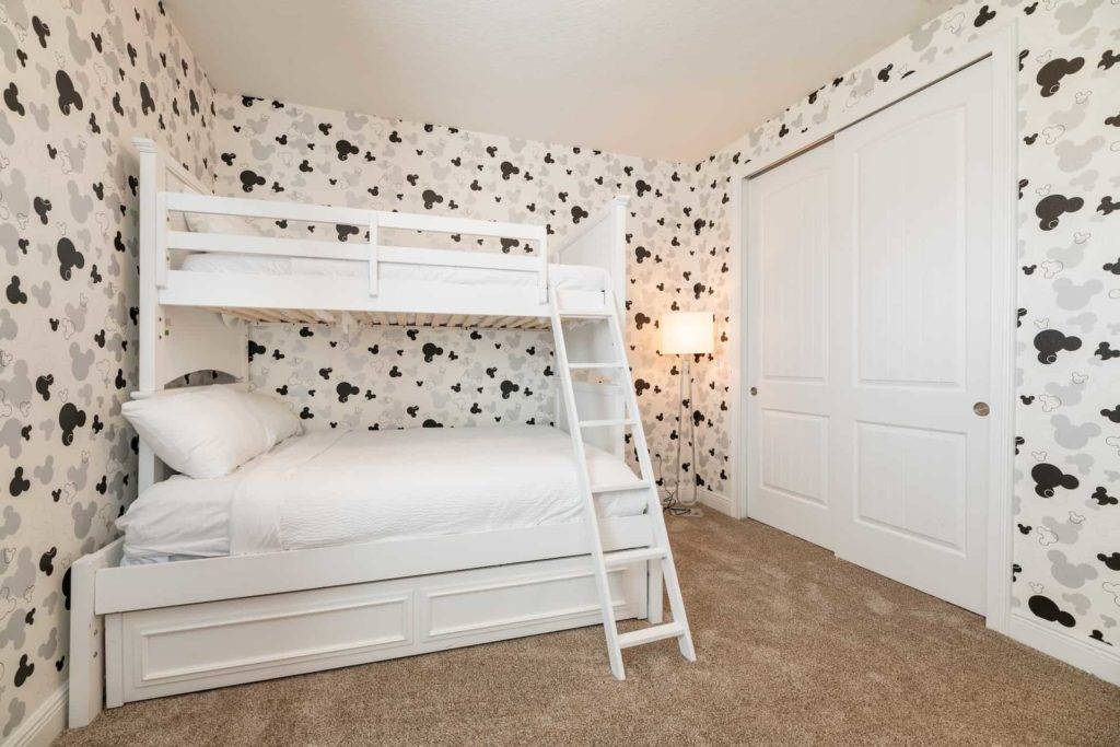 Kids’ bedroom with bunkbeds and Mickey Mouse wallpaper