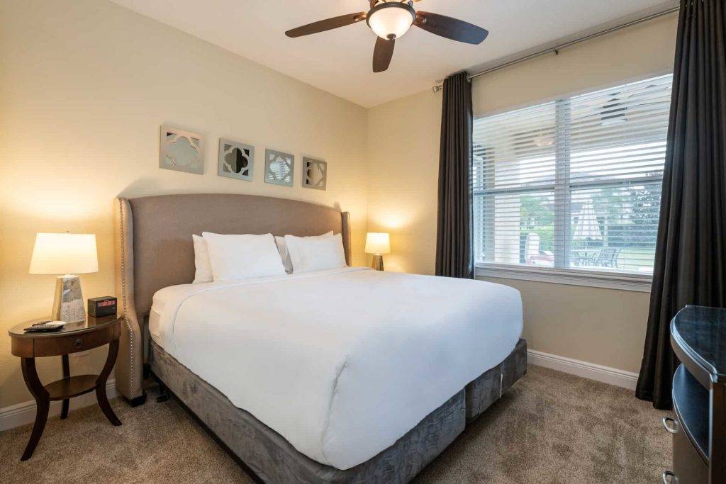 Bedroom 6 with king bed and view of private pool