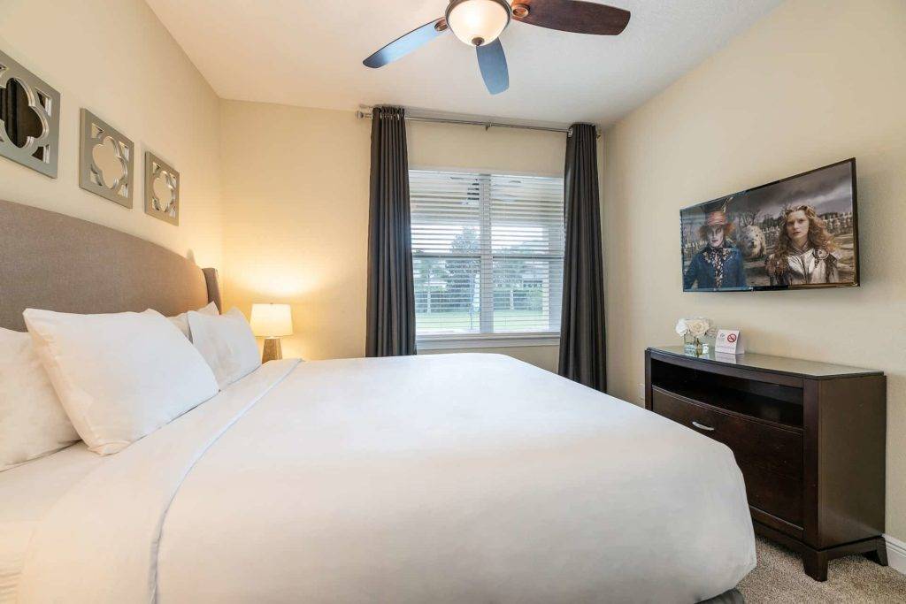 Bedroom 6 with king bed and wall-mounted TV