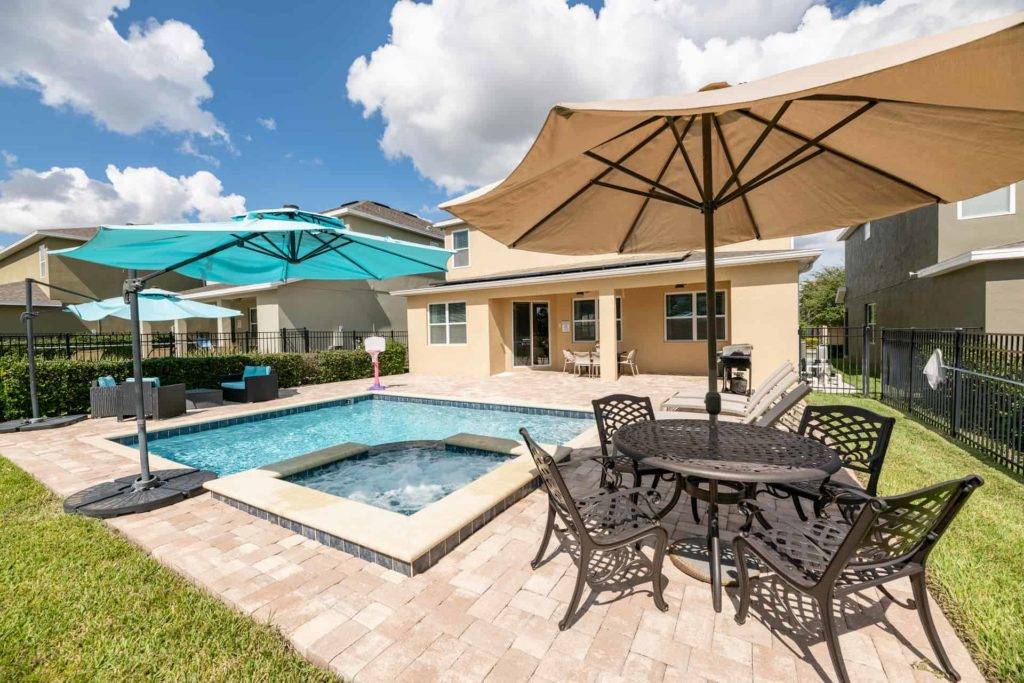 Backyard private hot tub and pool with covered dining table