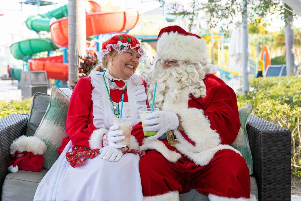 Santa and Mrs. Claus sitting in a private cabana at the Encore Resort Water Park