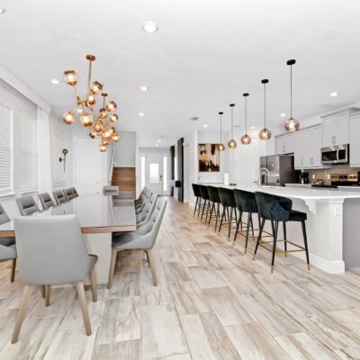 Kitchen and dining area with total seating for 20 between dining table and kitchen island