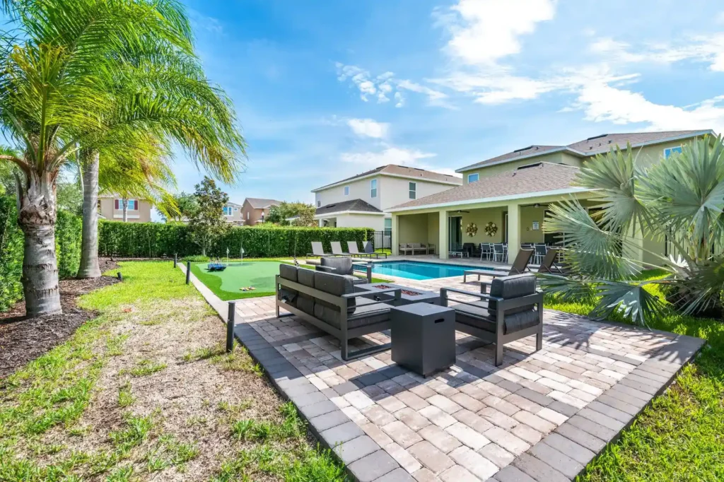 Private backyard with sitting area, putting green, pool, and covered lanai