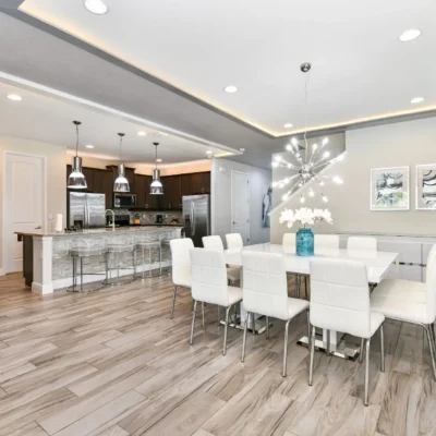 Spacious dining and kitchen area with table set for 12 and 4 additional seats at kitchen island counter