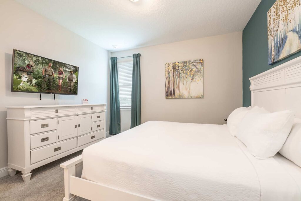 Bedroom 11 with queen bed, dresser, and wall-mounted TV