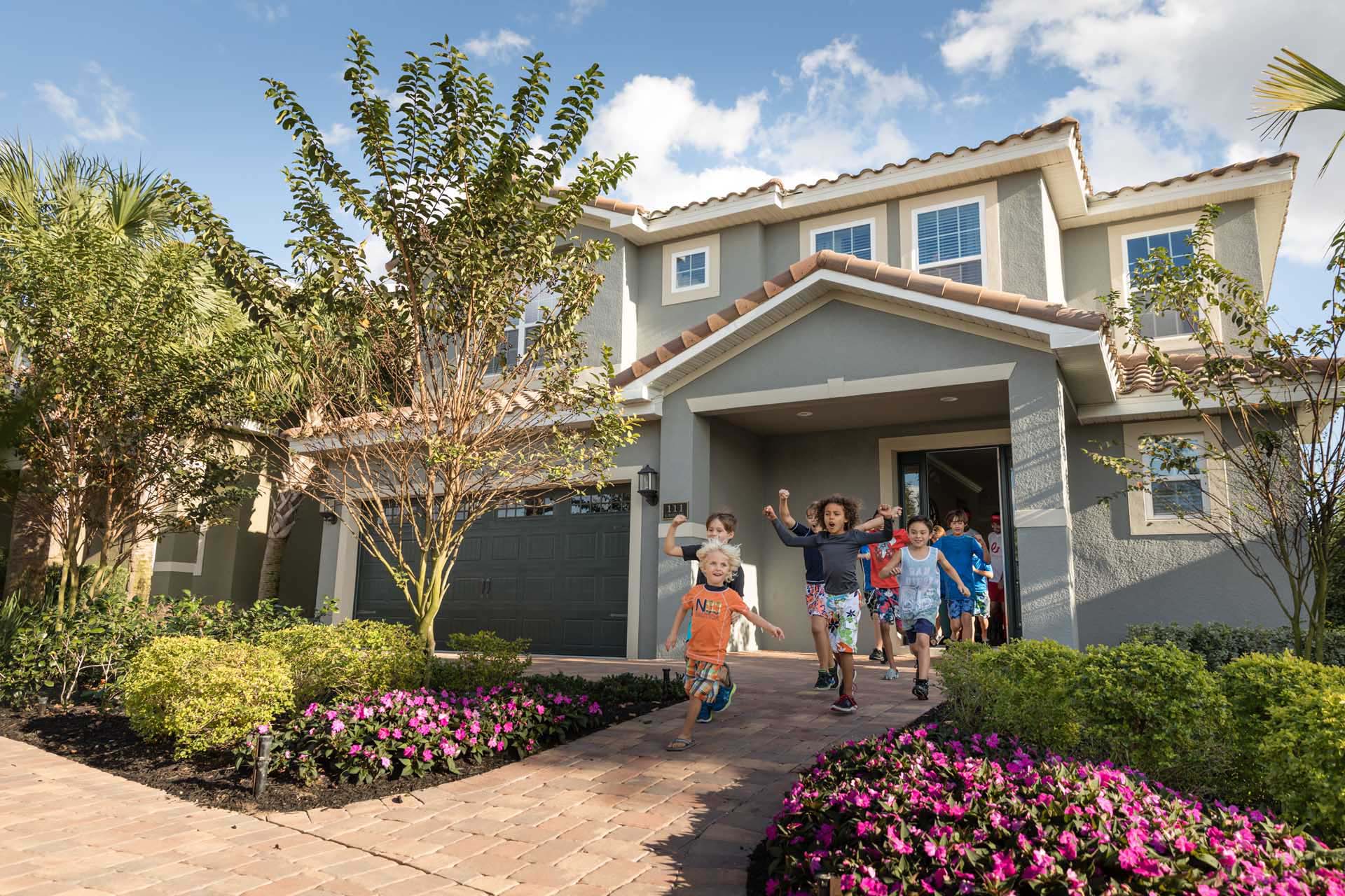 Group of young kids running out the door of an Encore Resort home