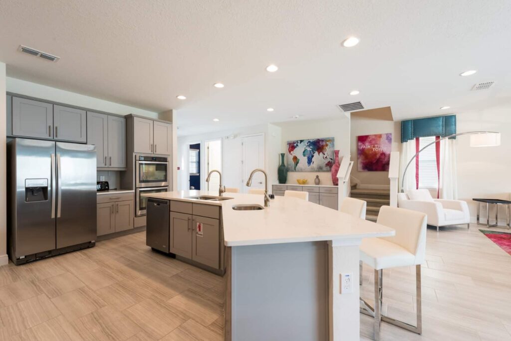 Fully equipped kitchen featuring large island with 2 sinks in an 11 Bedroom Vacation Home