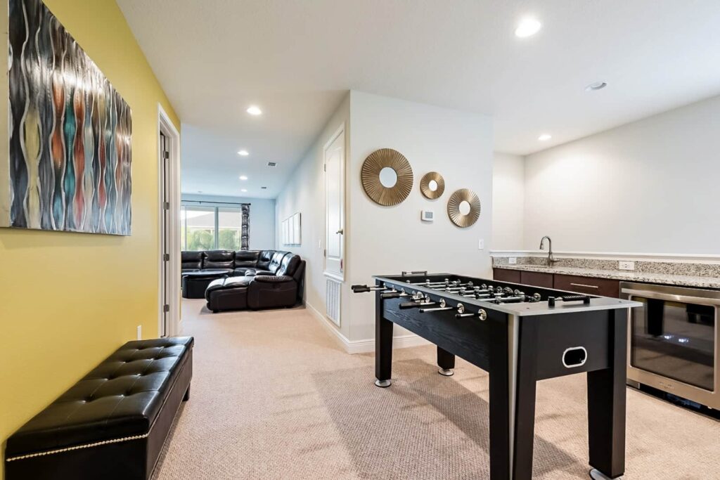 Lounge with foosball table and wet bar in an 11 Bedroom Vacation Home