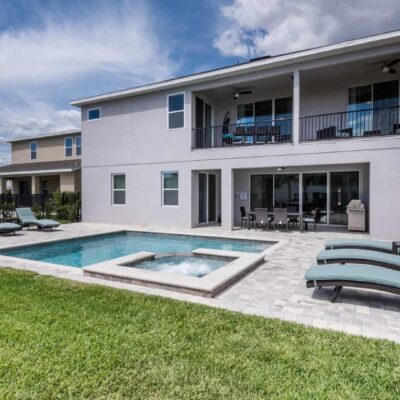 11 Bedroom Vacation Home private backyard with pool, hot tub, covered lanai, and balcony