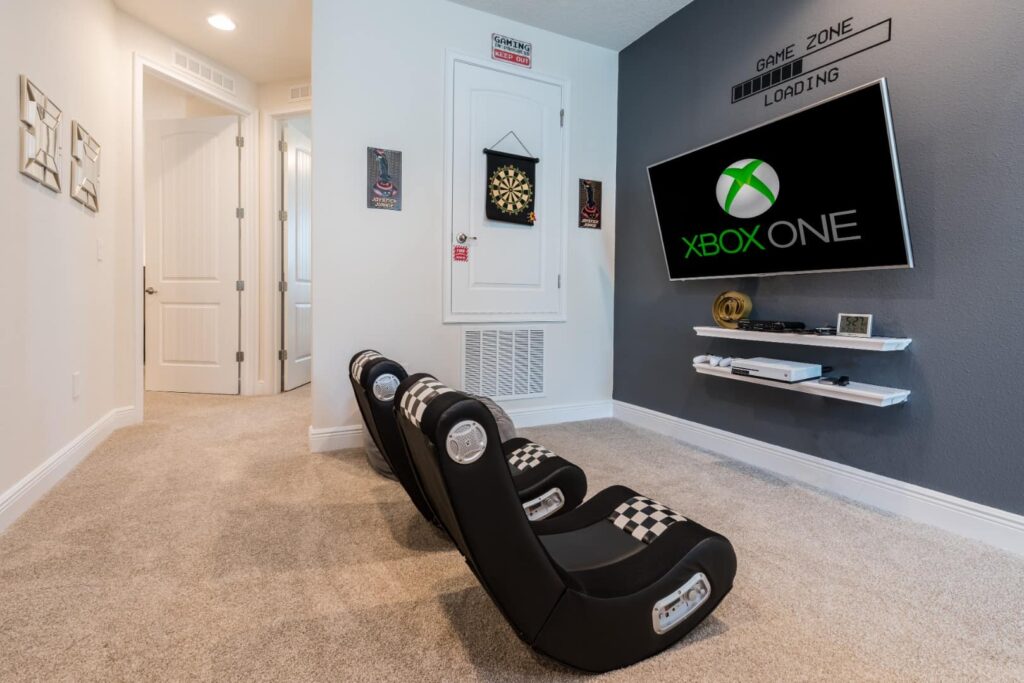 Game room with console, TV, and gaming chairs at a 4 Bedroom Elite Home