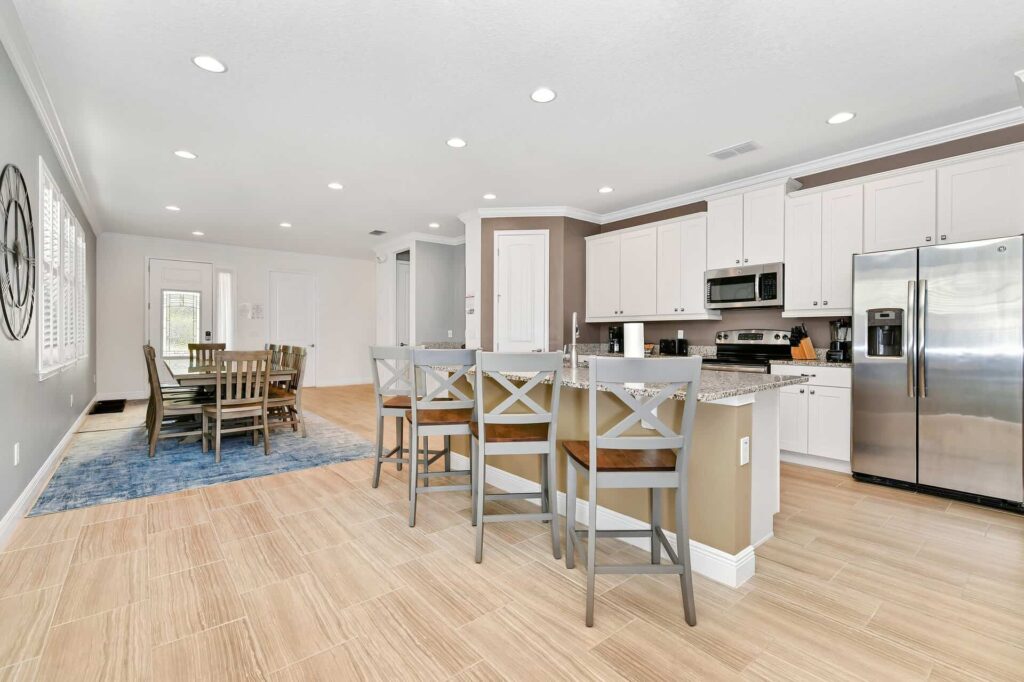 Full kitchen and dining areas with seating at dining table and kitchen countertop