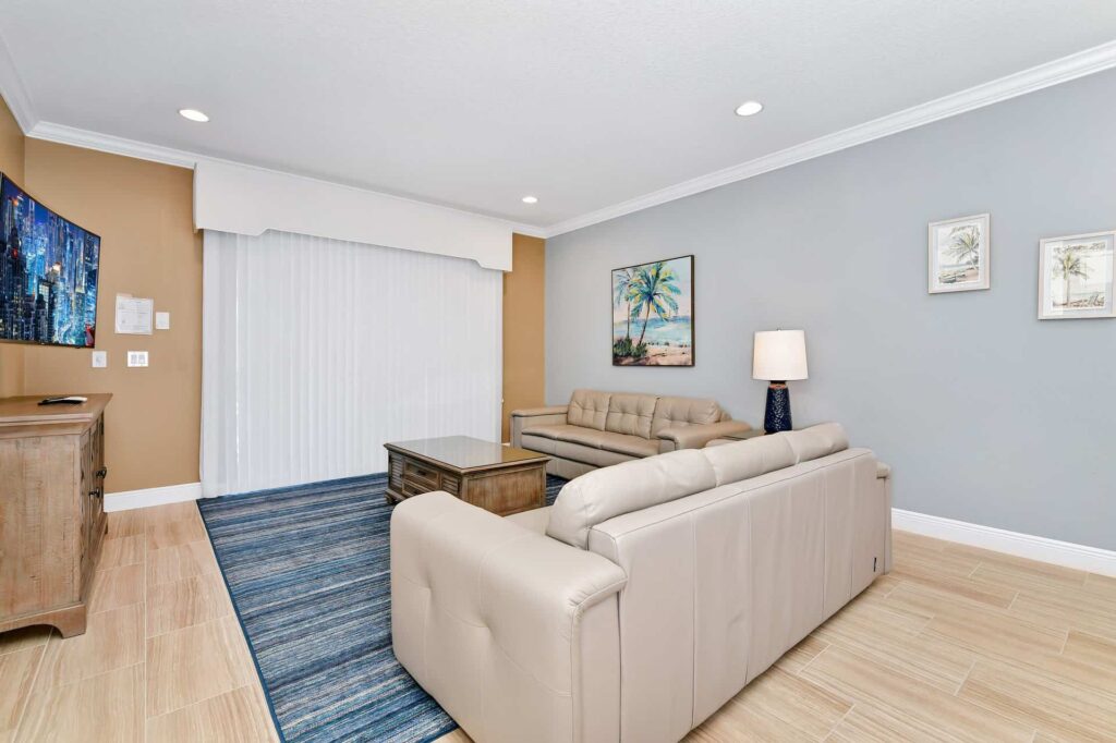 Living room with sofas, coffee table, and wall-mounted TV