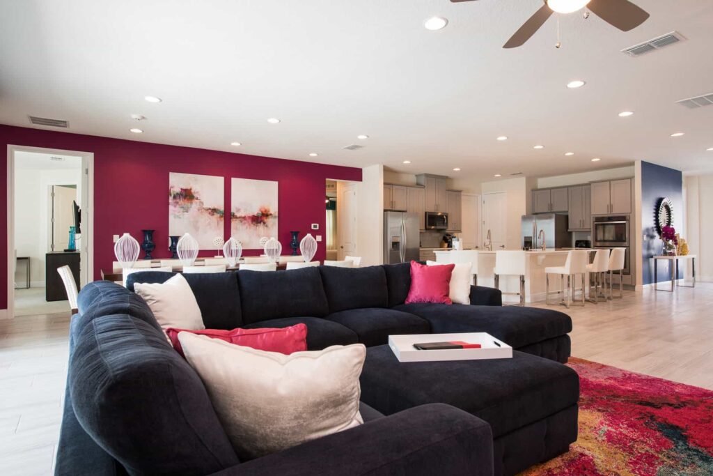 Living room with sectional sofa, ottoman, and throw pillows