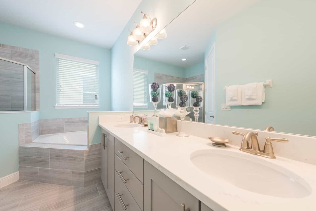 Bathroom 1 with double sinks, walk-in shower, and separate bathtub