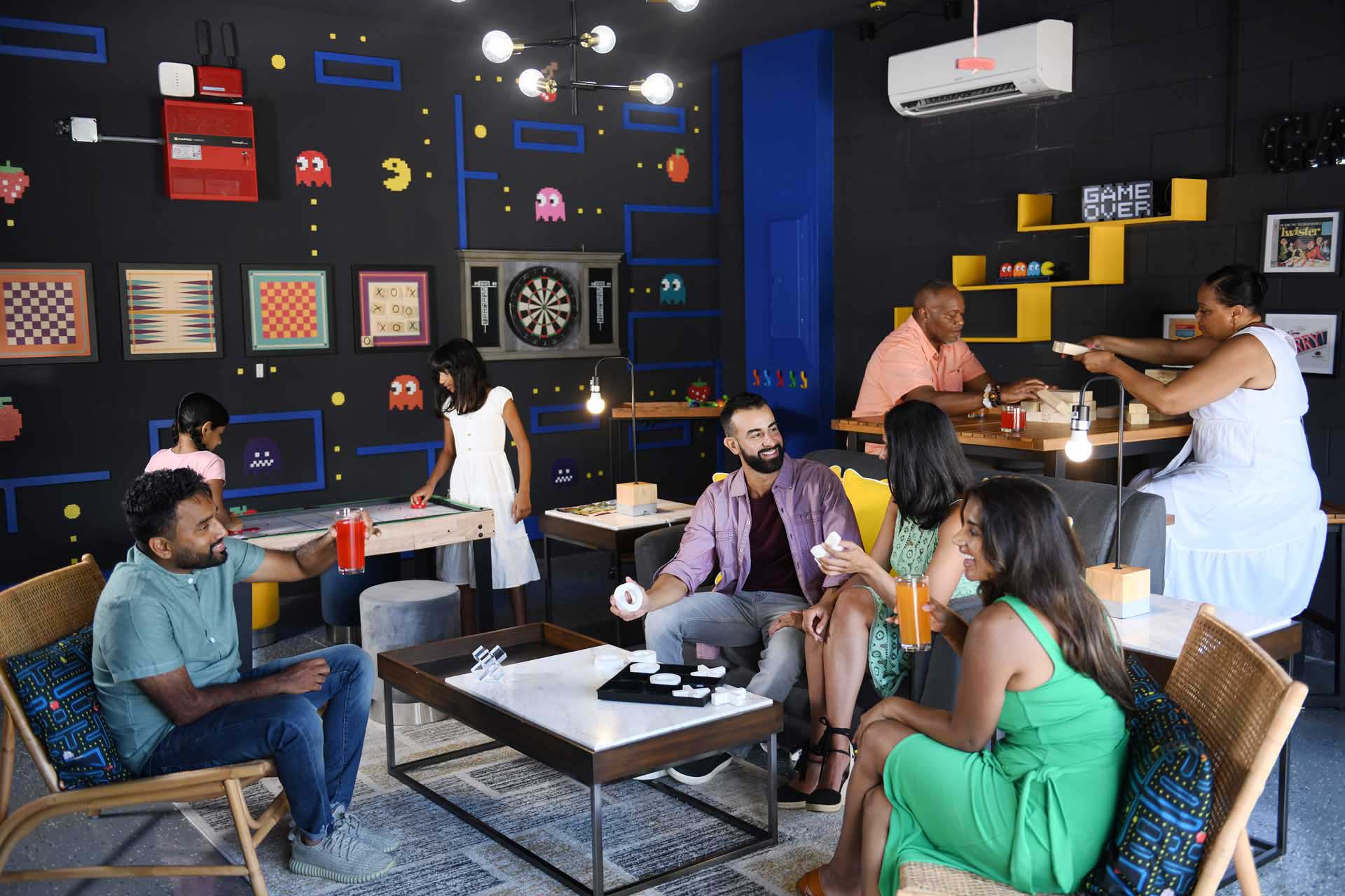 Large family playing games in their Encore Resort home game room