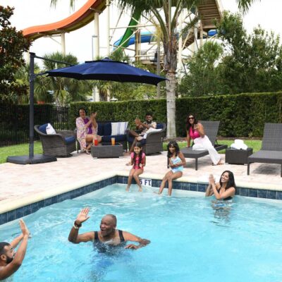 Large family having fun in their Encore Resort home private pool