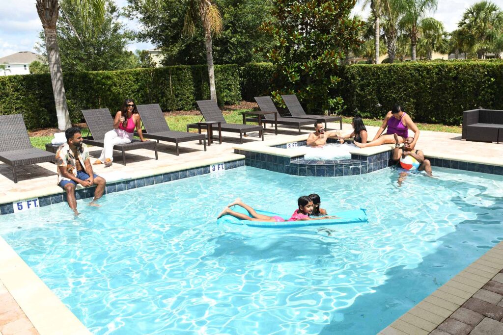 Large family having fun in their Encore Resort home private pool