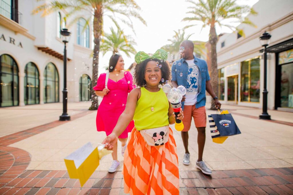 Family walking with shopping bags in Disney Springs